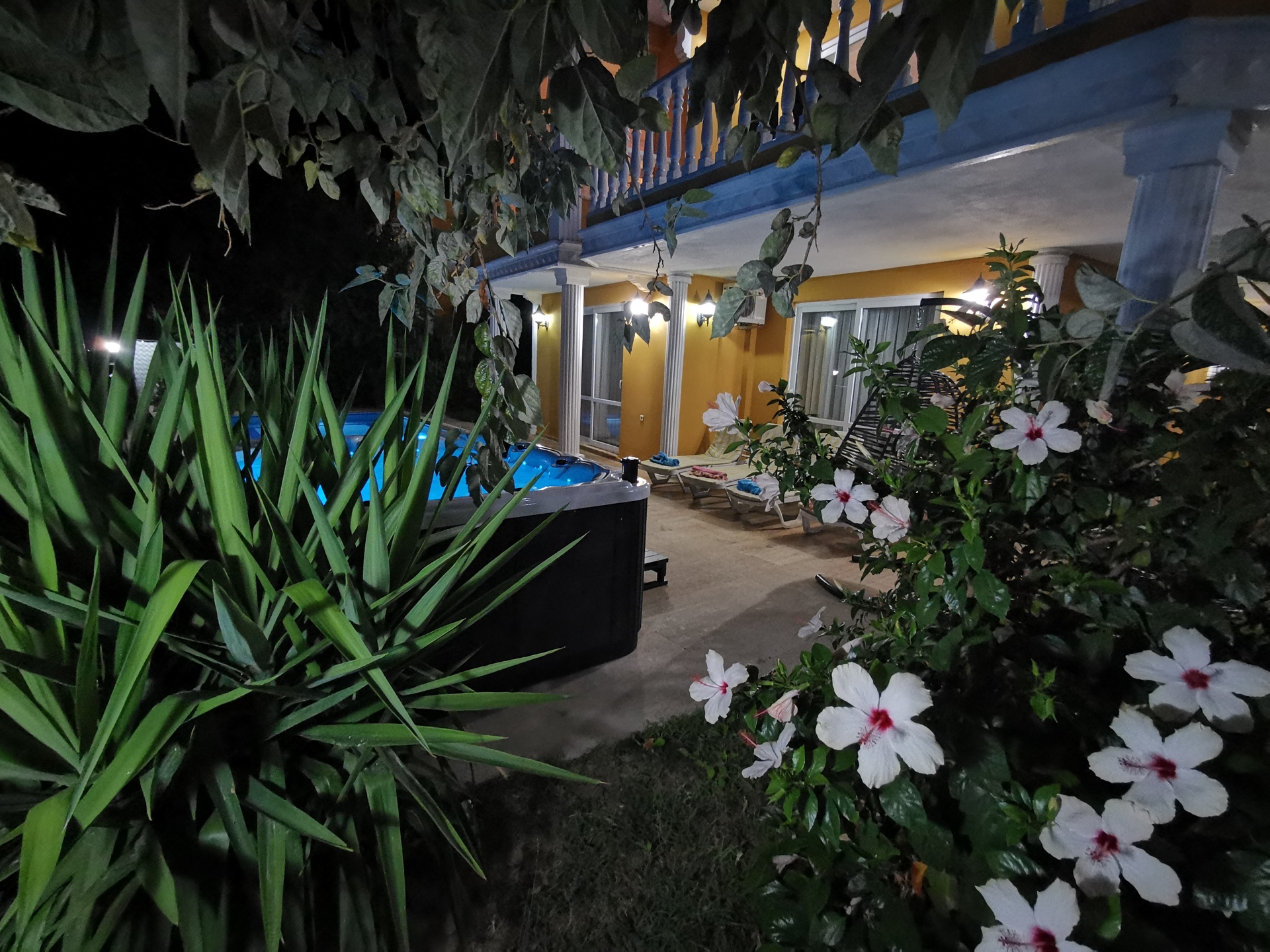 Lush trees and flowers surround the Jacuzzi, giving you more privacy