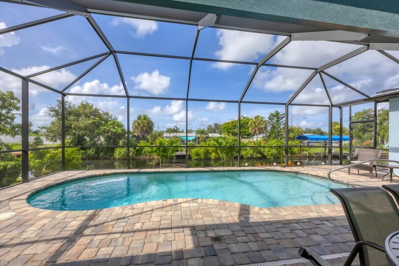 Gorgeous, large lanai with sparkling pool overlooking the canal. Lanai also features a dining table for 6 and 32-inch Smart TV. Pool size: 22' x 8' x 6'D