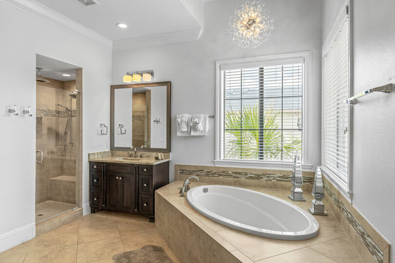 En-suite bathroom with large soaking tub and glass door walk-in shower