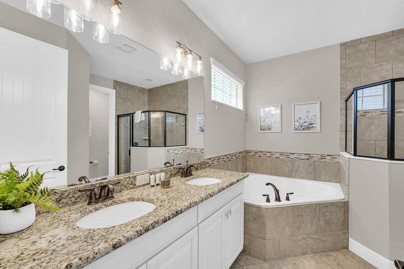 En-suite master bathroom has a walk in shower, garden tub, and dual vanity