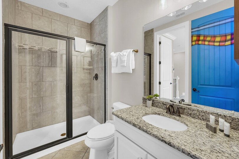 The kids en-suite bathroom features a walk in shower
