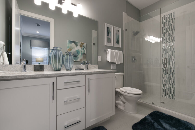 The master en-suite bathroom features a glass door walk in shower