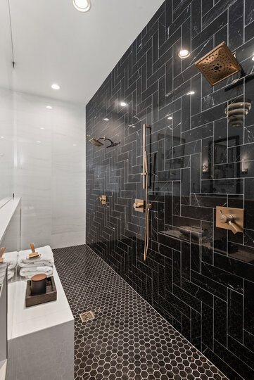 The ensuite bathroom has dual shower heads in the walk-in shower