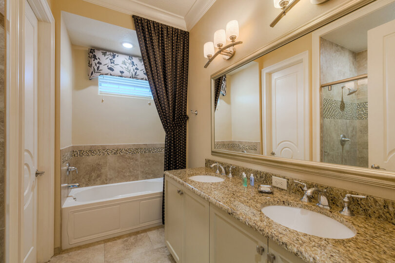 The en-suite bathroom 3 with dual vanity, bathtub, and walk-in shower